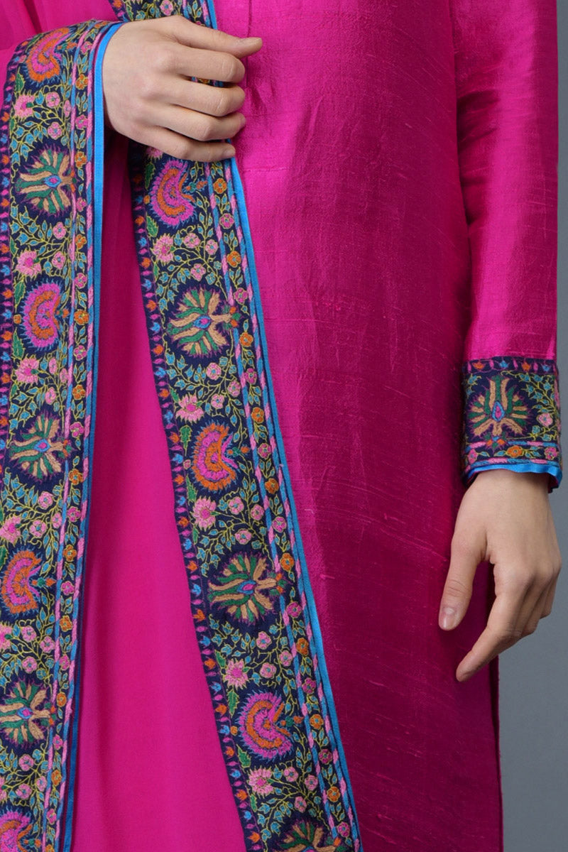Hot pink raw silk suit with multicolor Kashmiri hand embroidery and georgette dupatta borders