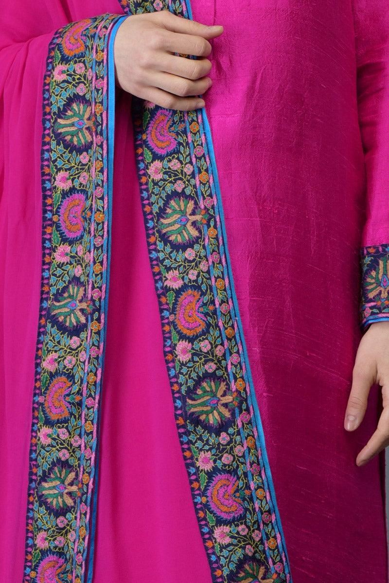 Hot pink raw silk suit with multicolor Kashmiri hand embroidery and georgette dupatta borders