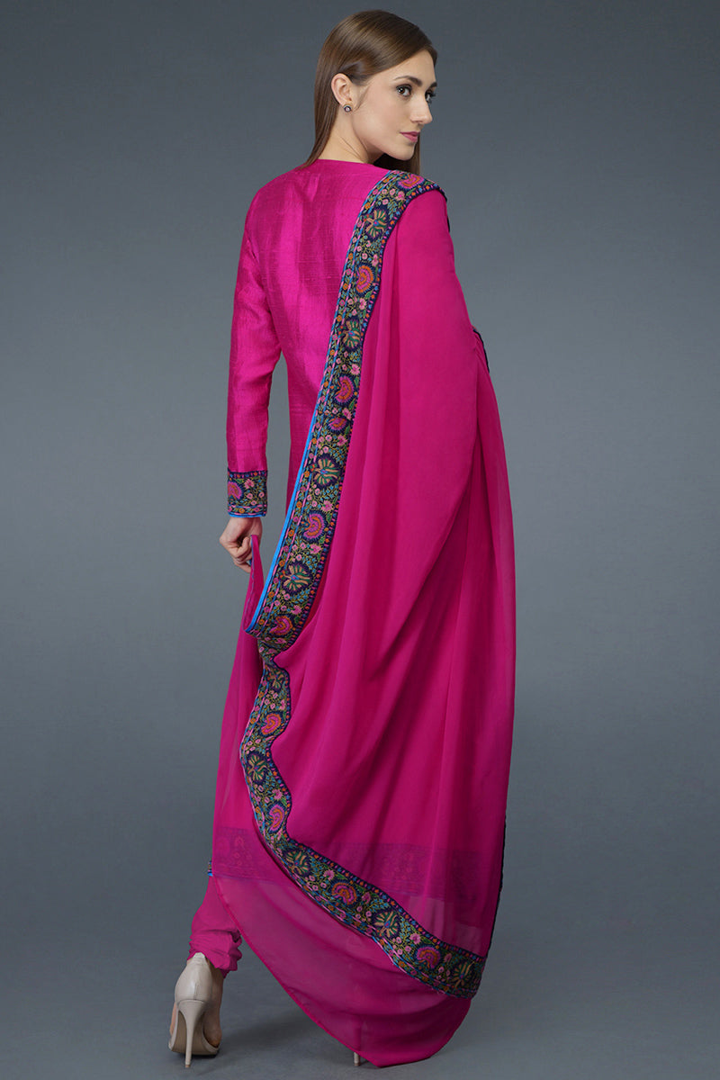 Hot pink raw silk suit with multicolor Kashmiri hand embroidery and georgette dupatta borders