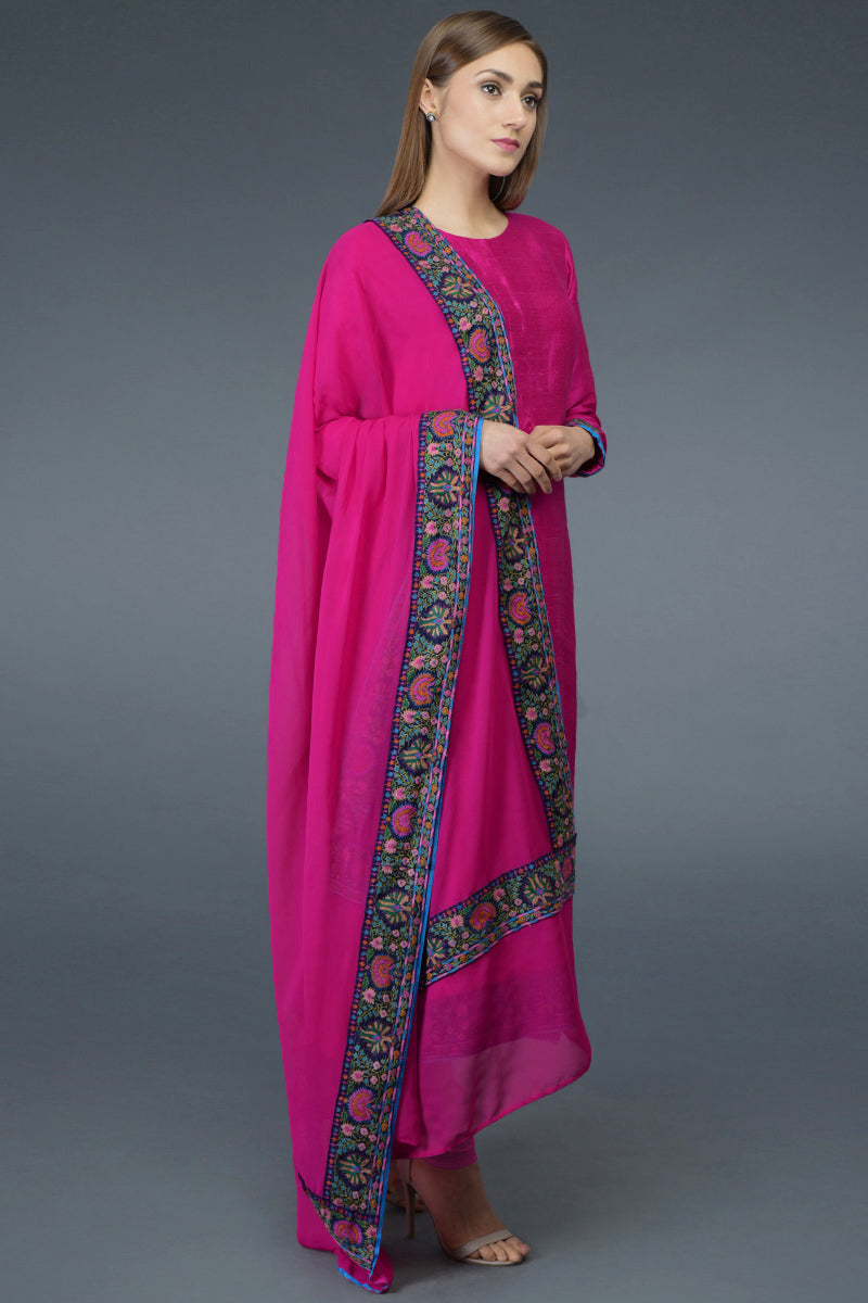 Hot pink raw silk suit with multicolor Kashmiri hand embroidery and georgette dupatta borders