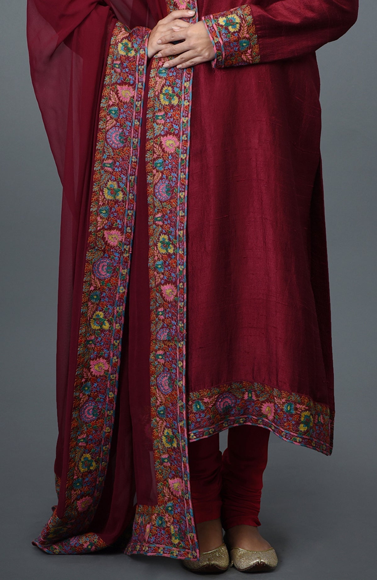 Maroon raw silk suit with jewel neckline and colorful Kashmiri hand embroidery on kurta and dupatta borders