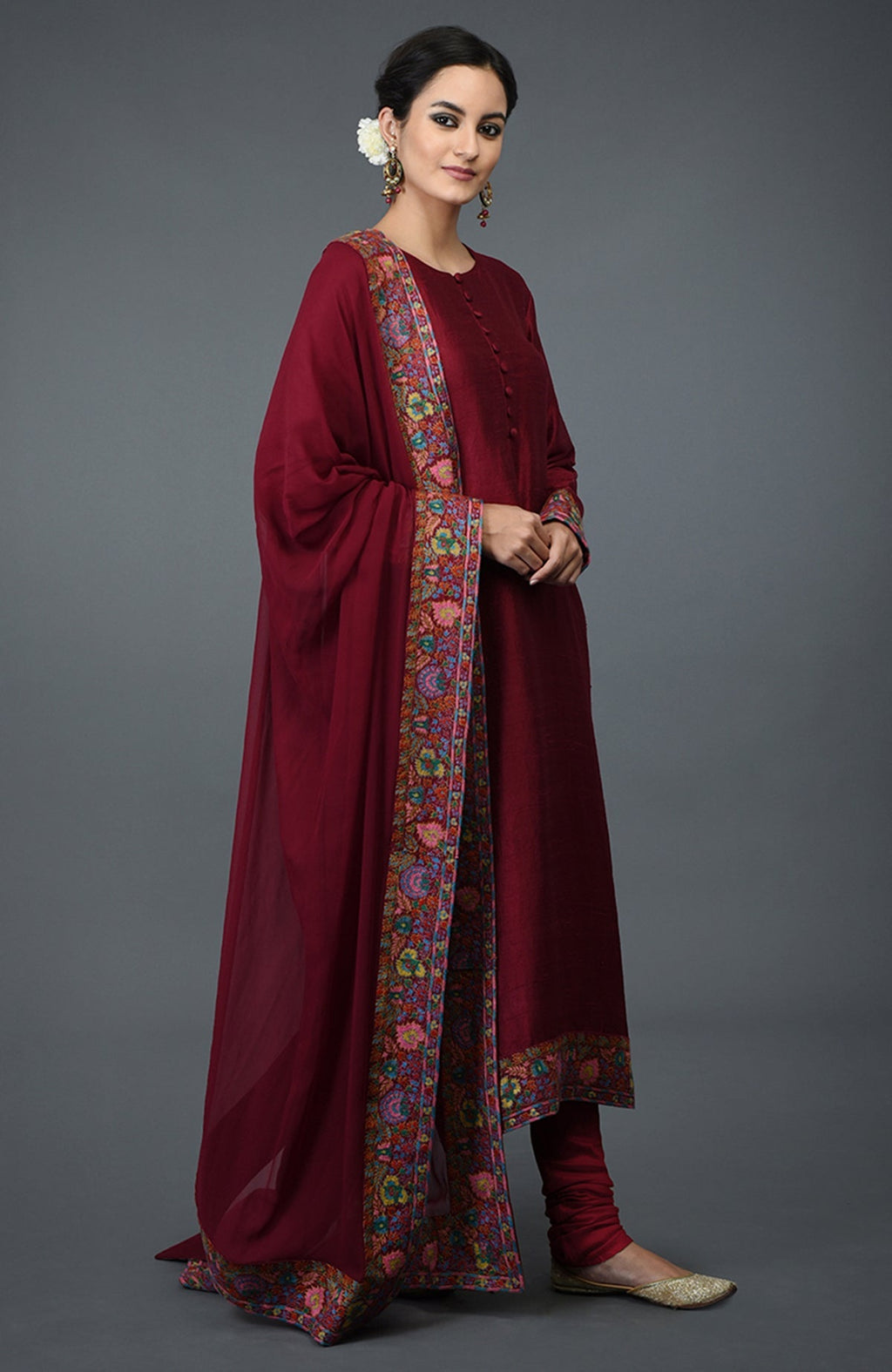 Maroon raw silk suit with jewel neckline and colorful Kashmiri hand embroidery on kurta and dupatta.