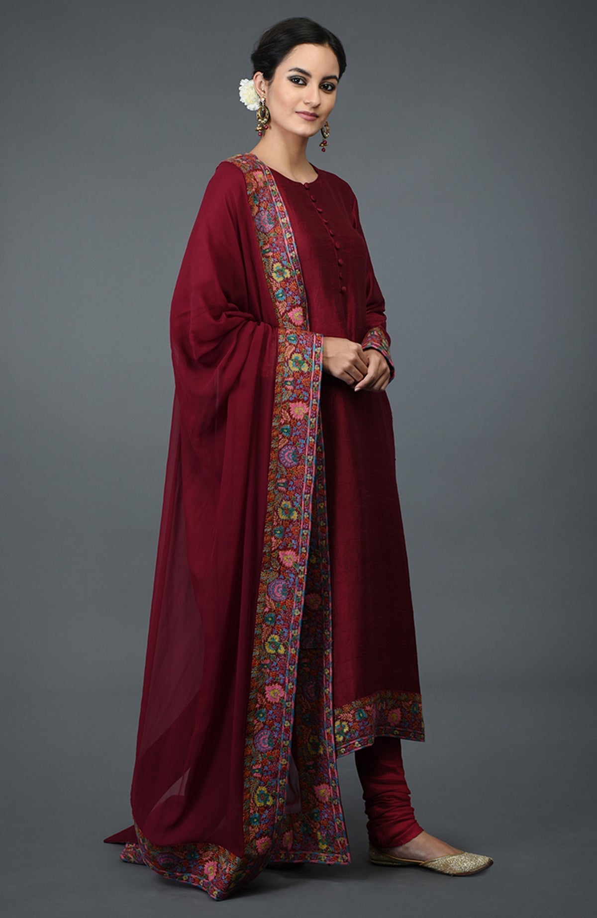 Maroon raw silk suit with jewel neckline and colorful Kashmiri hand embroidery on kurta and dupatta.