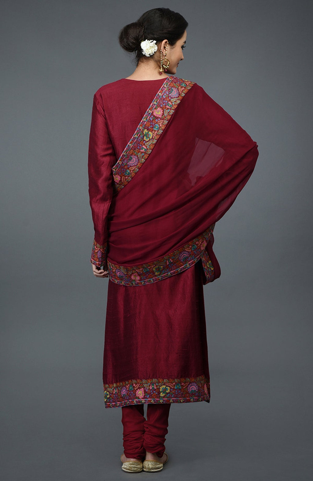 Maroon raw silk suit with jewel neckline and multicolor Kashmiri hand embroidery on kurta and dupatta.