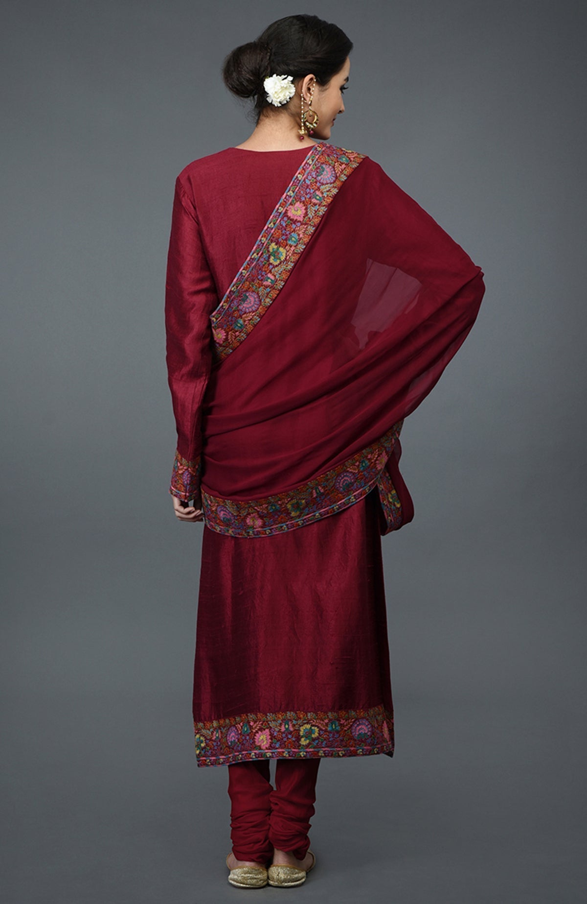 Maroon raw silk suit with jewel neckline and multicolor Kashmiri hand embroidery on kurta and dupatta.