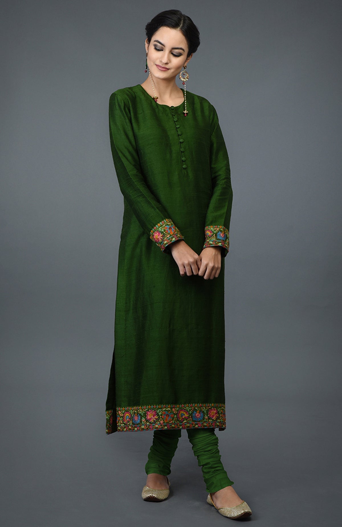 Moss green raw silk suit with colorful Kashmiri hand embroidery and georgette dupatta borders.