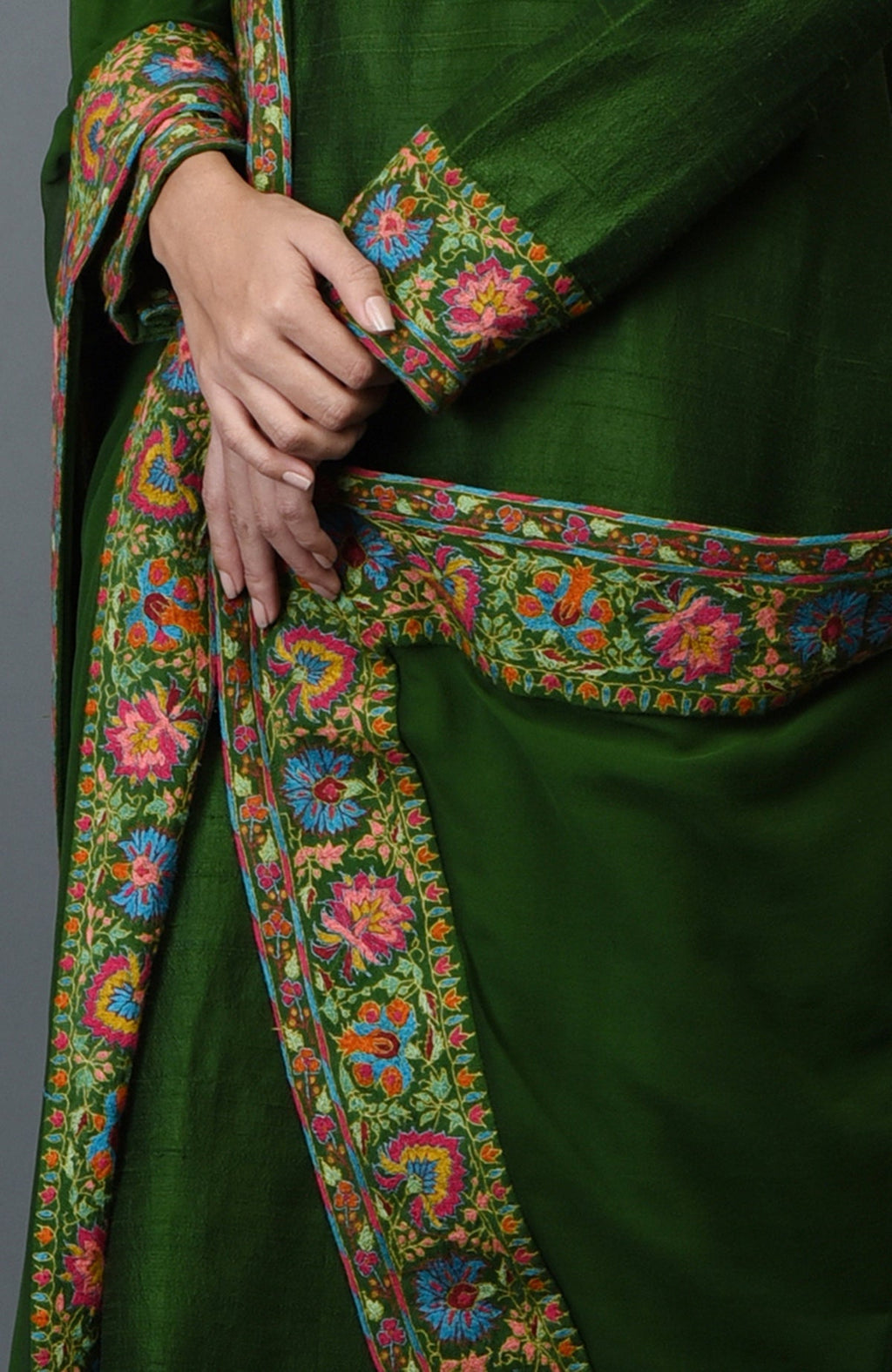 Moss green raw silk suit with multicolor Kashmiri hand embroidery and georgette dupatta borders.