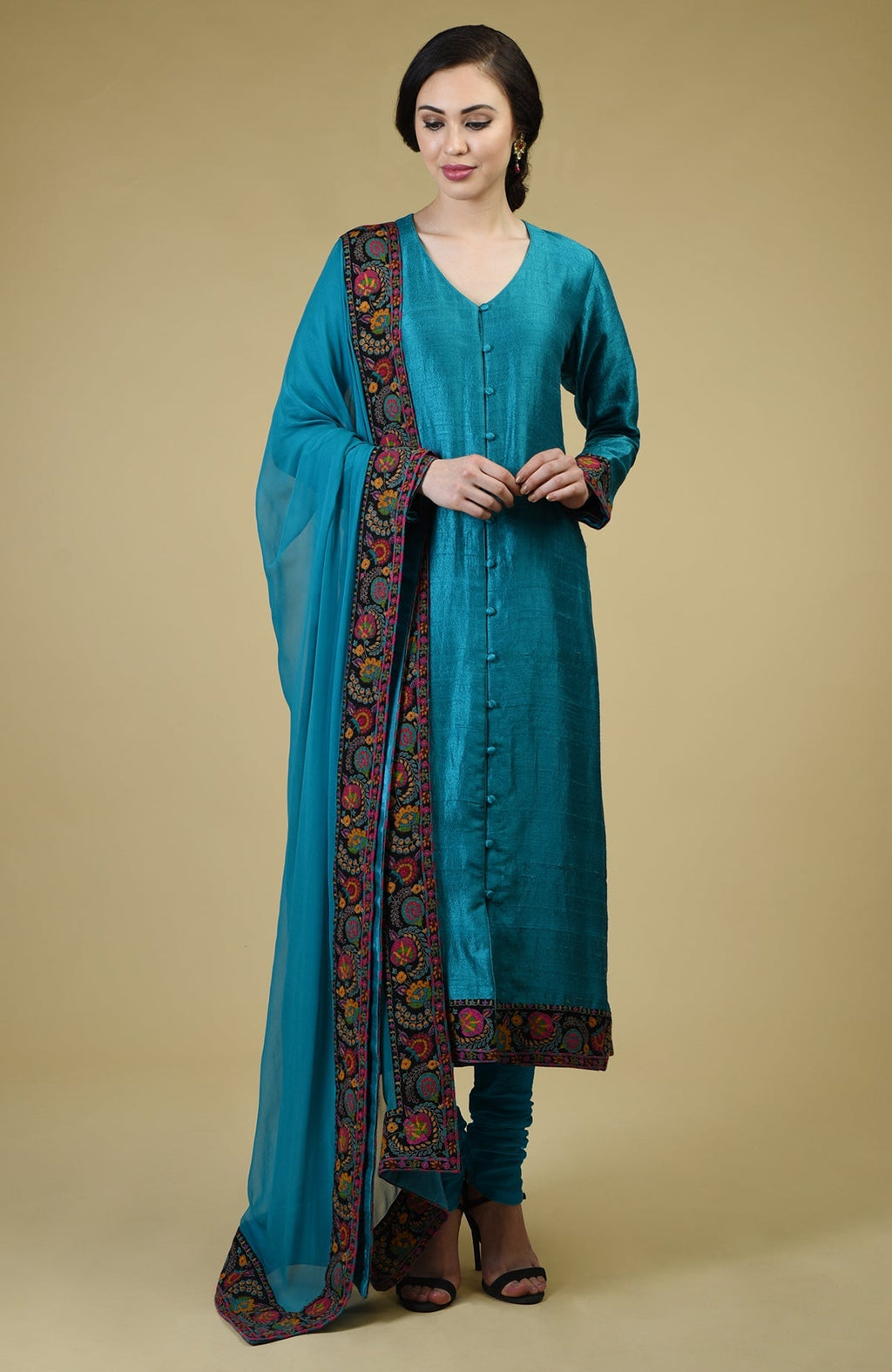 Teal blue raw silk suit with Kashmiri hand embroidery and georgette dupatta borders.