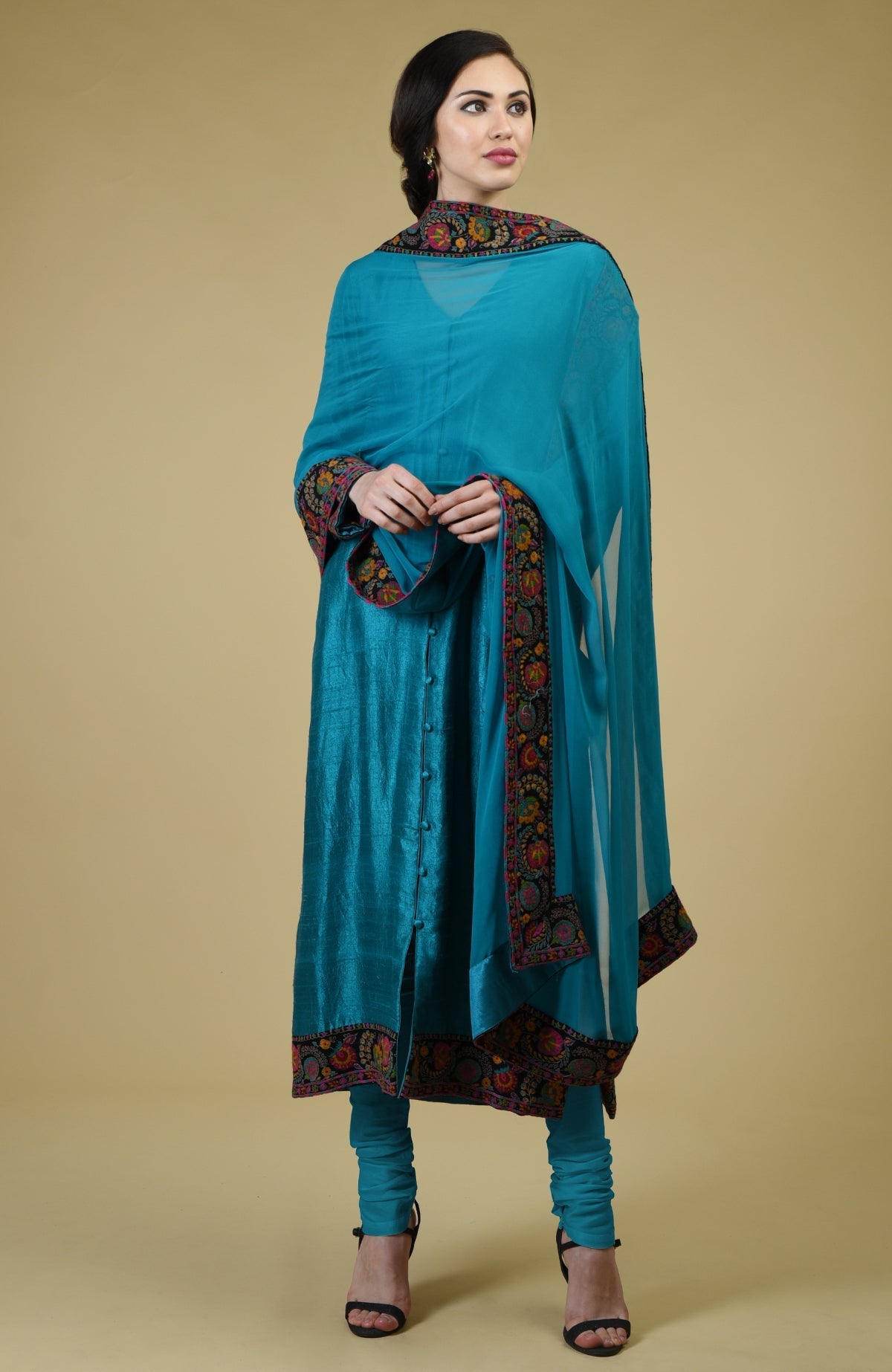 Teal blue raw silk suit with Kashmiri hand embroidery on kurta and dupatta borders.