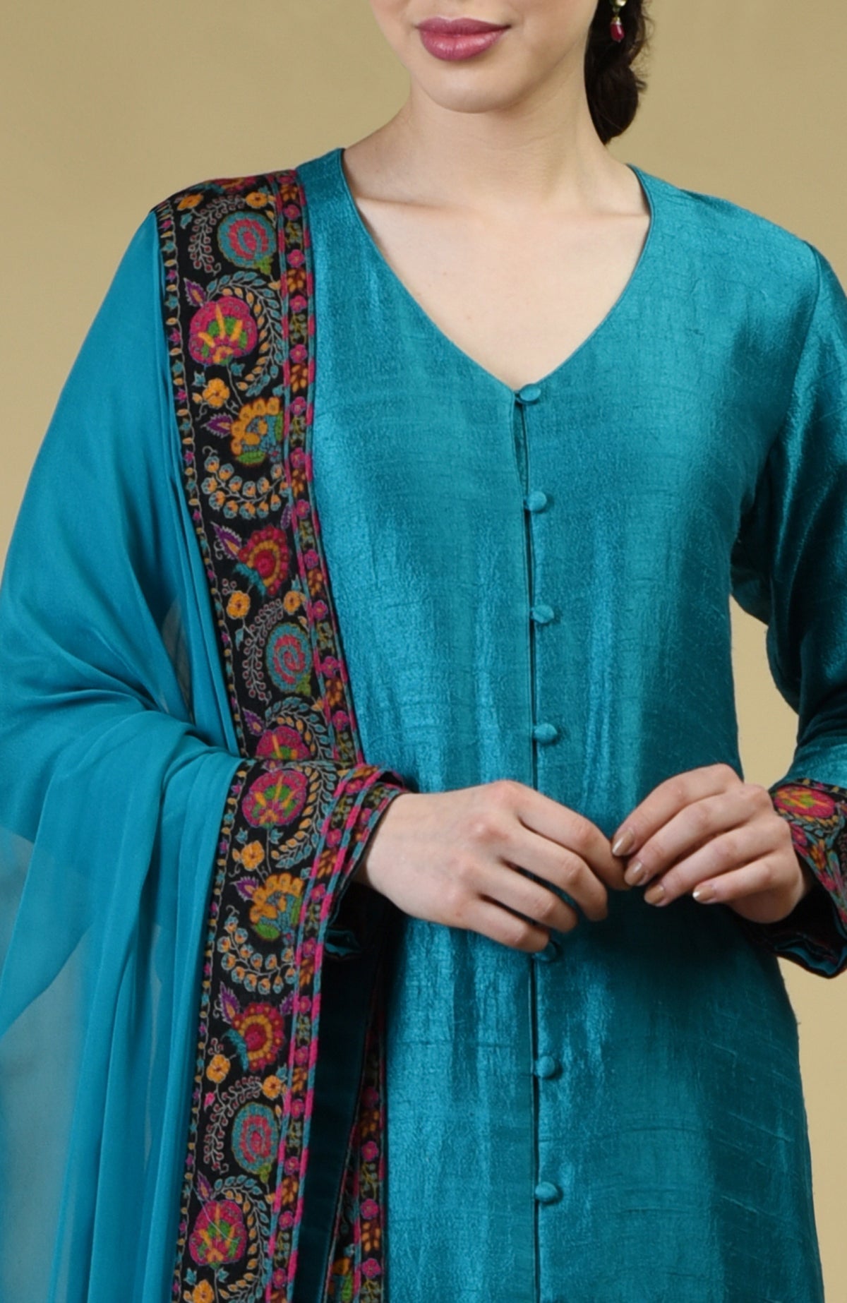 Teal blue raw silk suit with Kashmiri hand embroidery on kurta and dupatta borders.