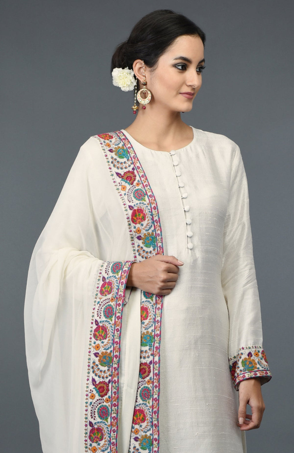 Ivory raw silk suit with colorful Kashmiri hand embroidery on kurta and dupatta borders.