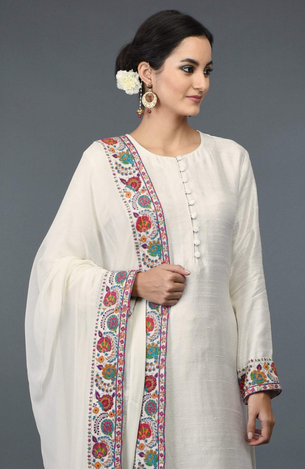 Ivory raw silk suit with colorful Kashmiri hand embroidery on kurta and dupatta borders.
