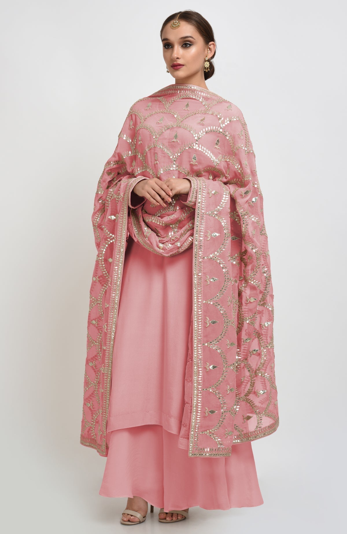 Oyster pink suit with rose gold gota patti embroidery on dupatta and shirt neckline.