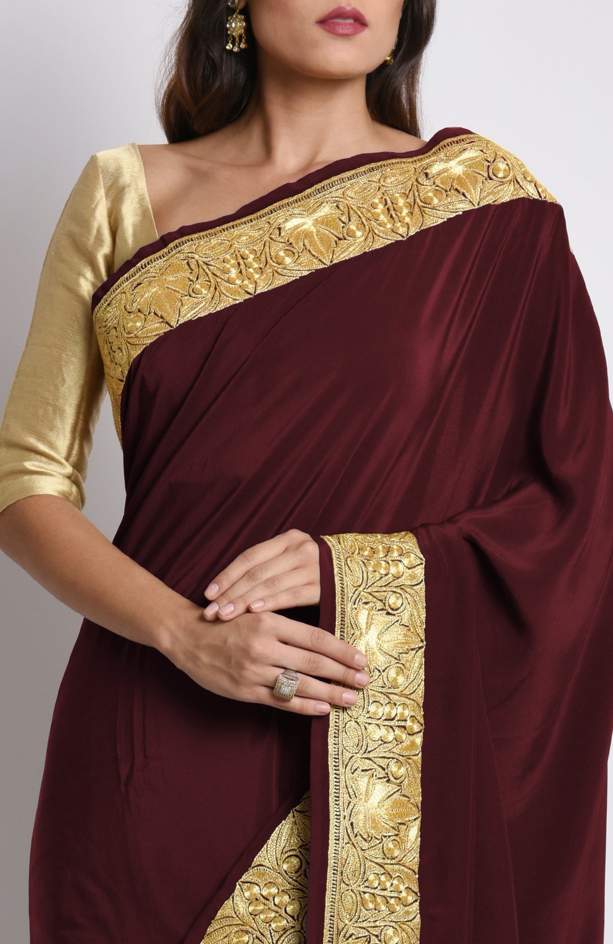Burgundy pure crepe saree with gold Kashmiri tilla embroidery on pallav and borders