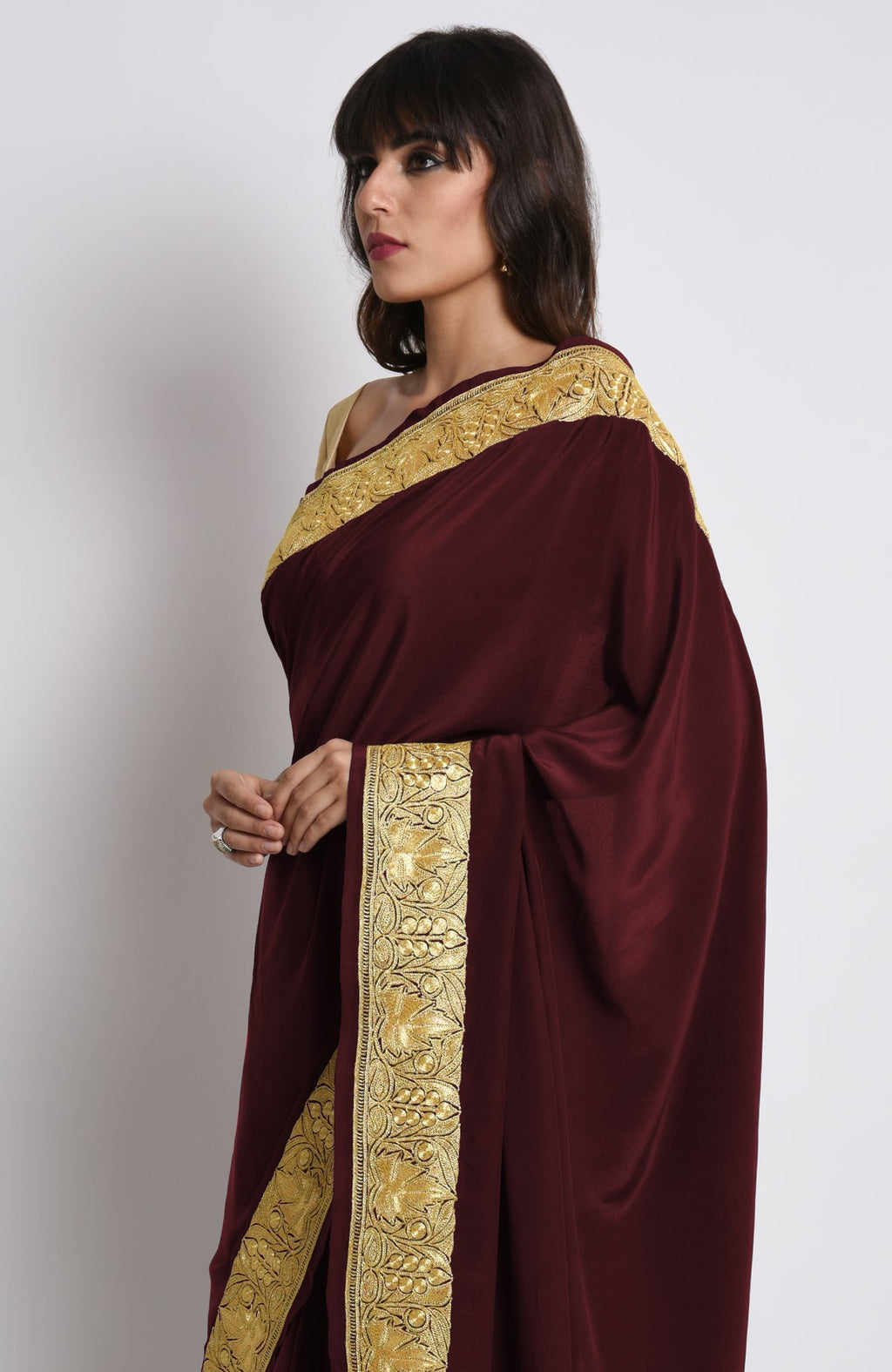 Burgundy pure crepe saree with gold Kashmiri tilla embroidery on pallav and borders