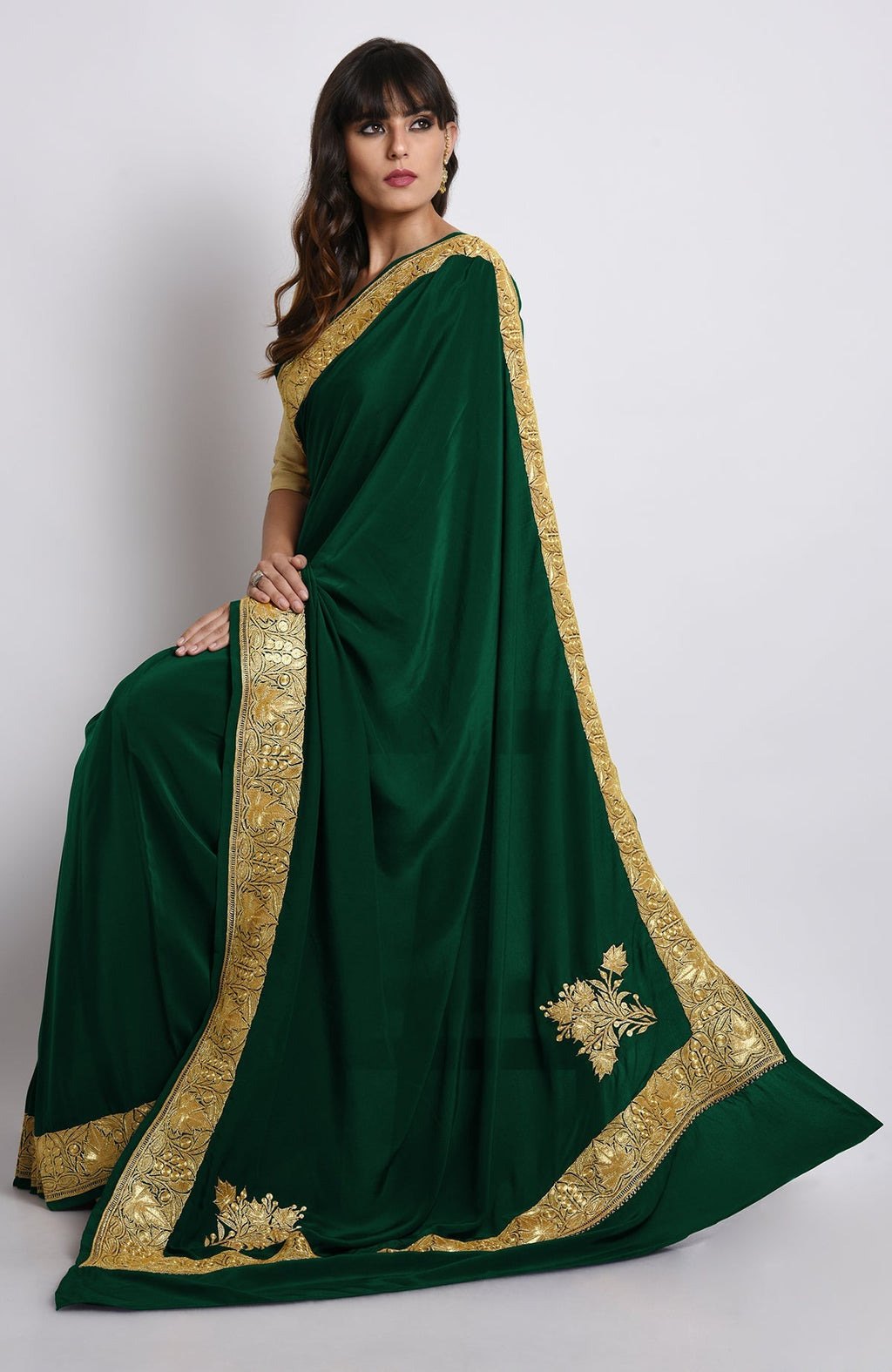 Emerald green crepe saree with gold Kashmiri tilla embroidery on pallav and borders