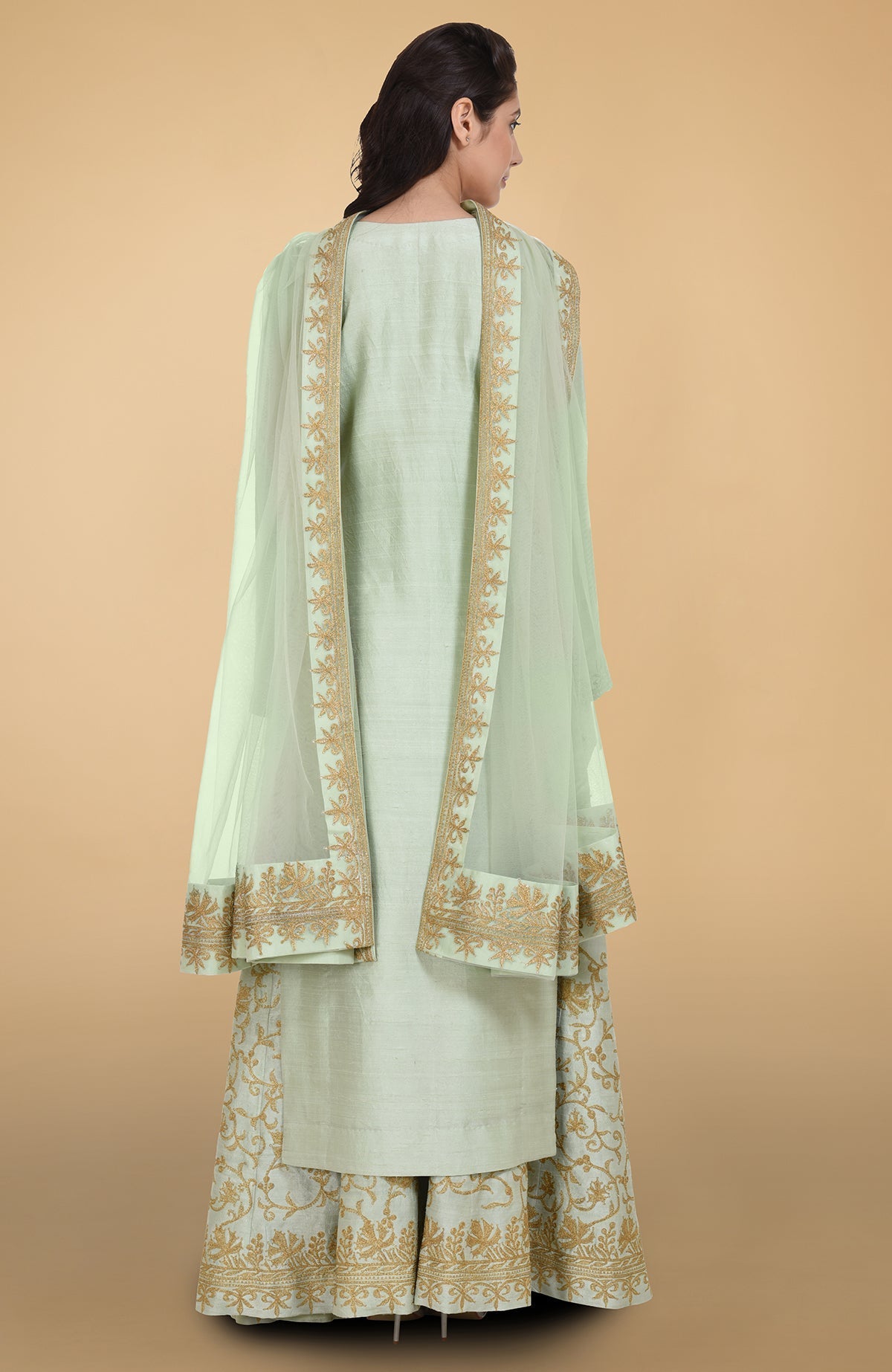 Sage green raw silk lehenga set with gold Kashmiri tilla aari embroidery and net dupatta.