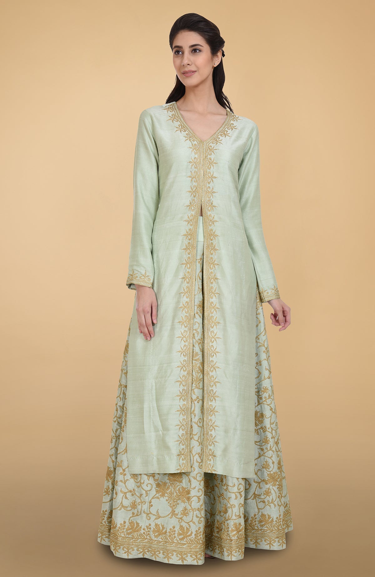 Sage green raw silk lehenga set with gold Kashmiri tilla aari embroidery and net dupatta.