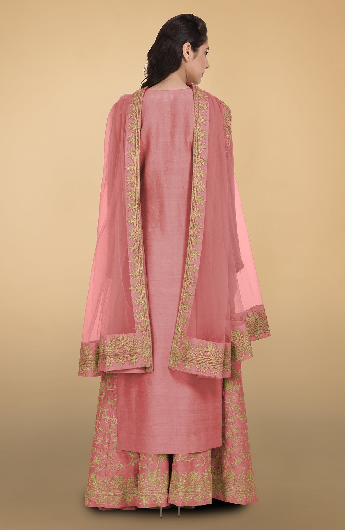 Peach echo raw silk lehenga set with gold Kashmiri tilla aari embroidery and net dupatta.