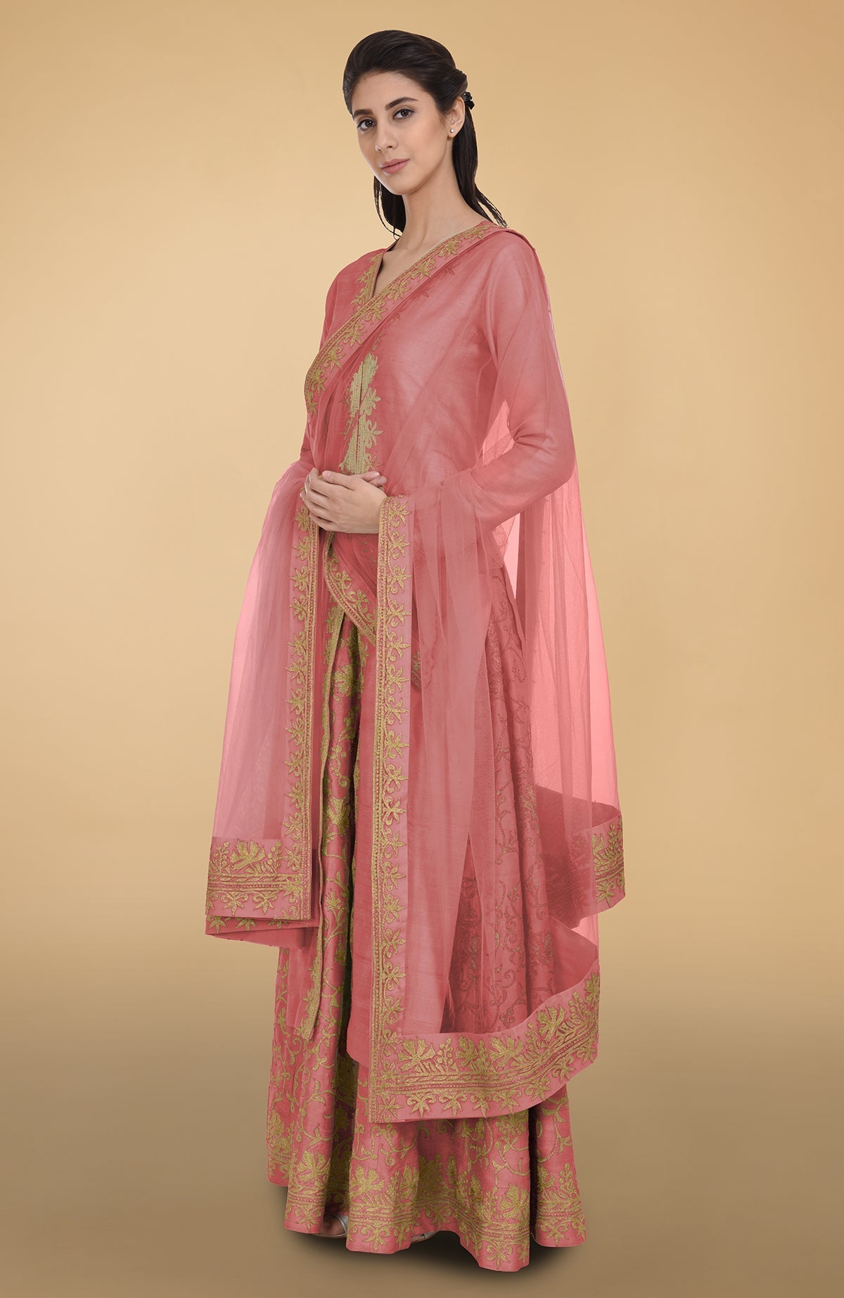 Peach echo raw silk lehenga set with gold Kashmiri tilla aari embroidery and net dupatta.