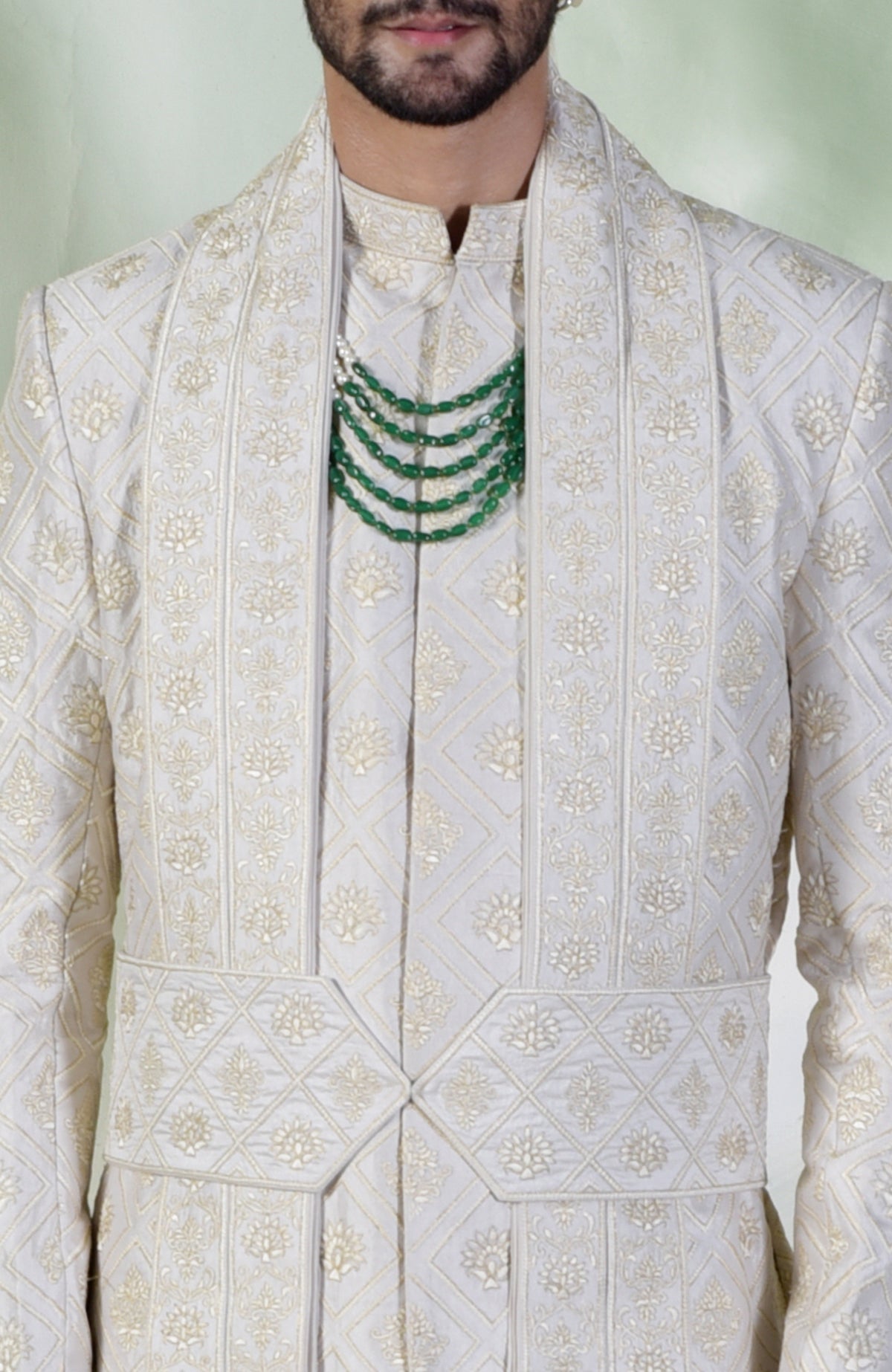 Ivory sherwani set with geometric and floral embroidery in silk and gold tilla threads.