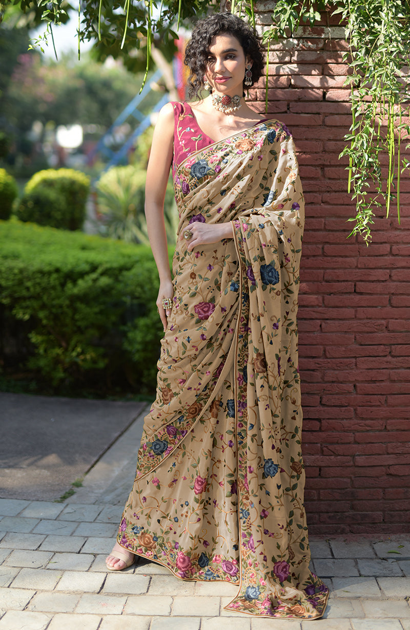 Beige floral Parsi Gara hand-embroidered saree with a wine blouse.