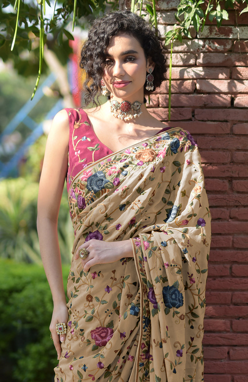 Beige floral Parsi Gara hand embroidered saree with a wine blouse.