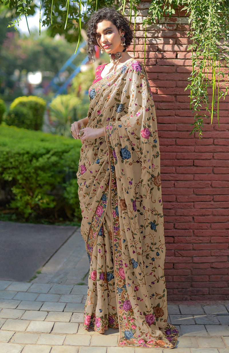Beige floral Parsi Gara hand embroidered saree with a wine blouse.