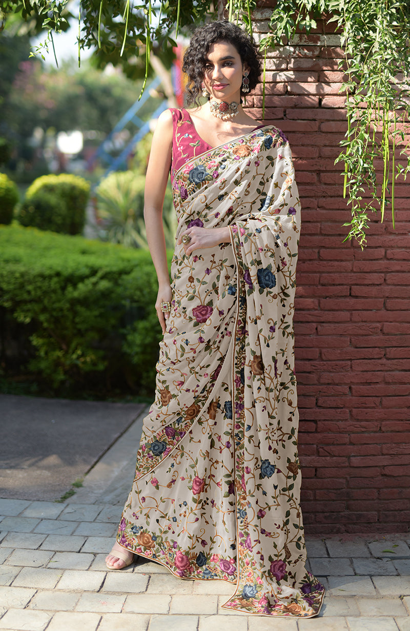 Cream floral Parsi Gara hand embroidered saree with a wine blouse.