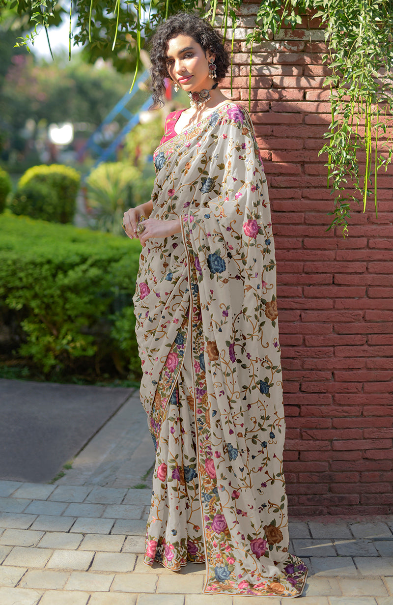 Cream floral Parsi Gara hand embroidered saree with a wine blouse.