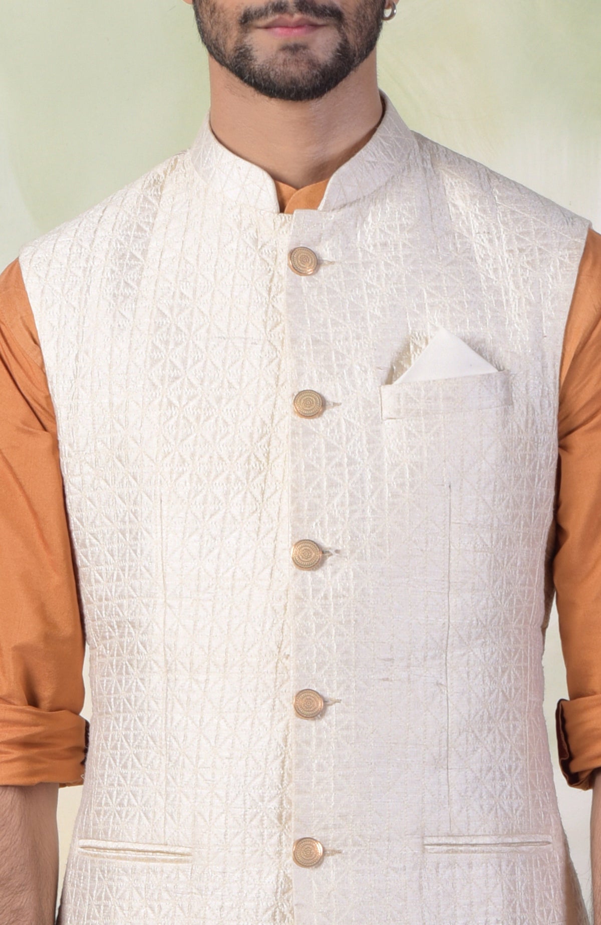Ivory micro-quilted raw silk bandi jacket with gold buttons in a classic minimalist style