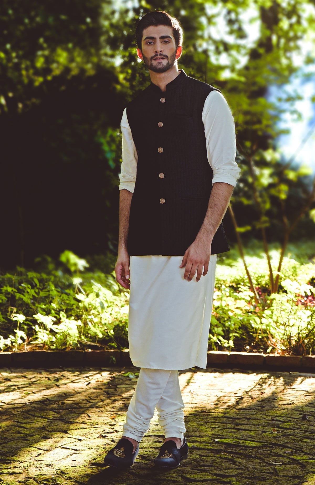 Black micro-quilted silk bandi jacket with gold buttons and a minimalist design