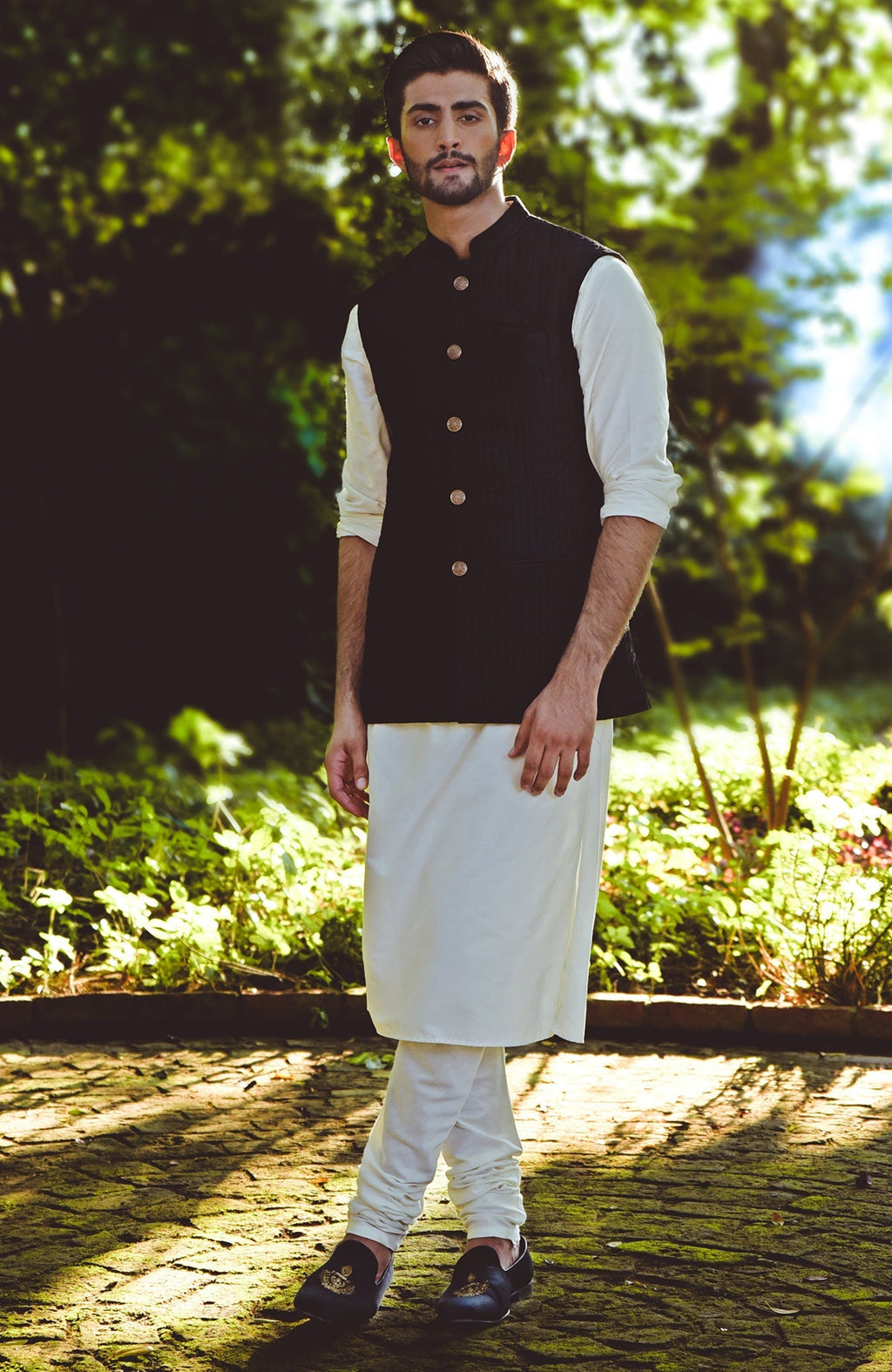 Black micro-quilted silk bandi jacket with gold buttons in a minimalist style