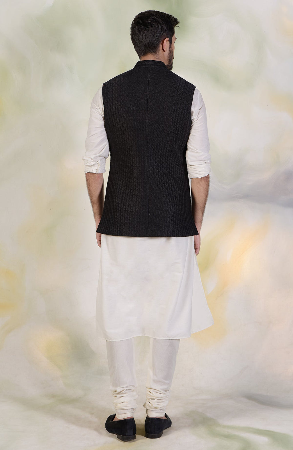 Black micro-quilted raw silk bandi jacket with gold buttons in classic minimalist style