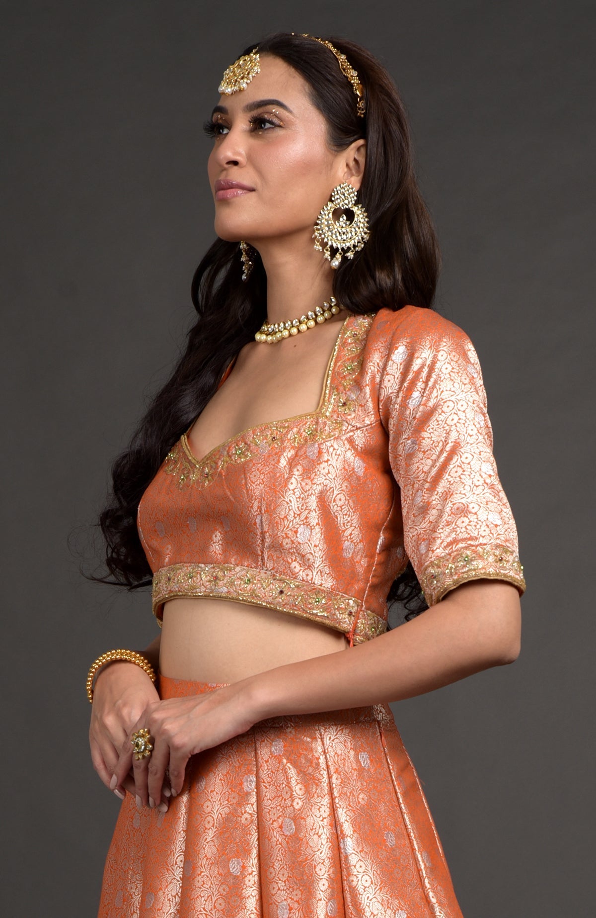 Orange-gold Benarasi weave blouse with zardozi floral embroidery and cut bead details.