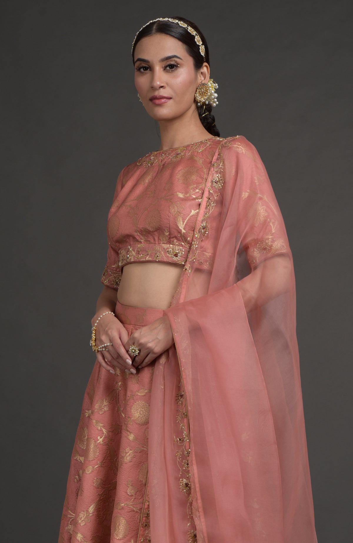 Desert rose-gold embroidered lehenga set with zardozi floral details and matching dupatta.
