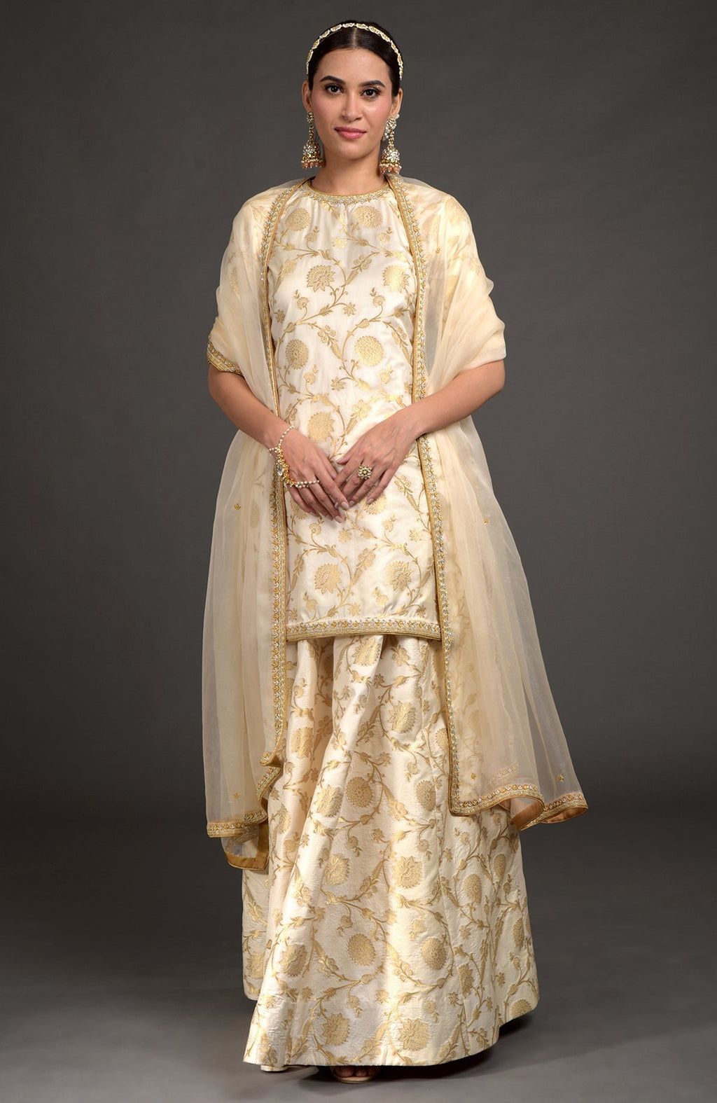 Ivory and gold Benarasi lehenga set with zardozi embroidery, tunic, and beaded dupatta.