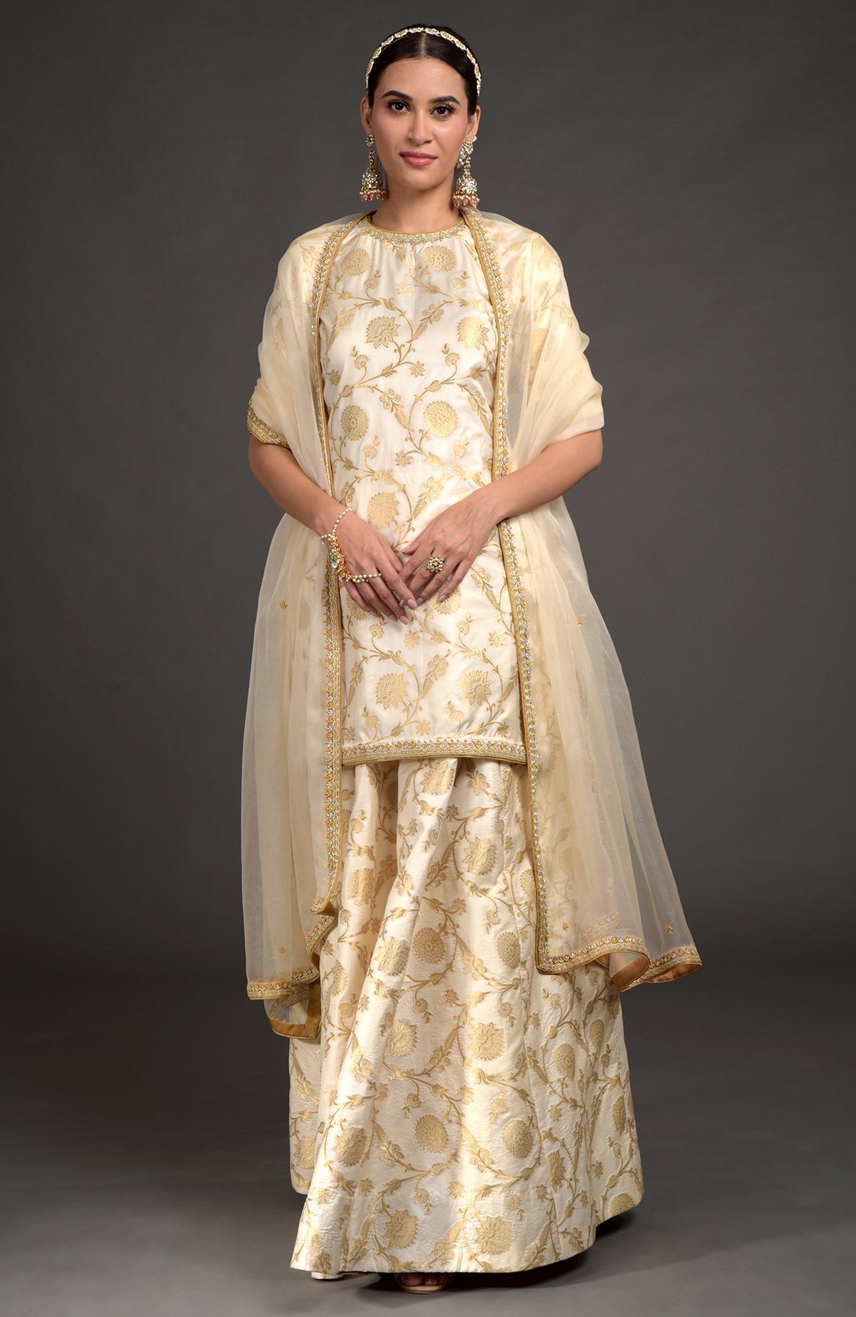 Ivory and gold Benarasi lehenga set with zardozi embroidery, tunic, and beaded dupatta.