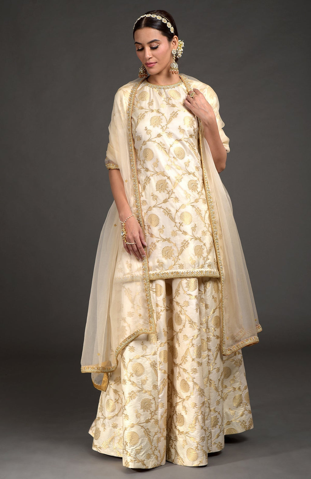 Ivory and gold Benarasi lehenga set with zardozi embroidery on tunic, dupatta, and skirt
