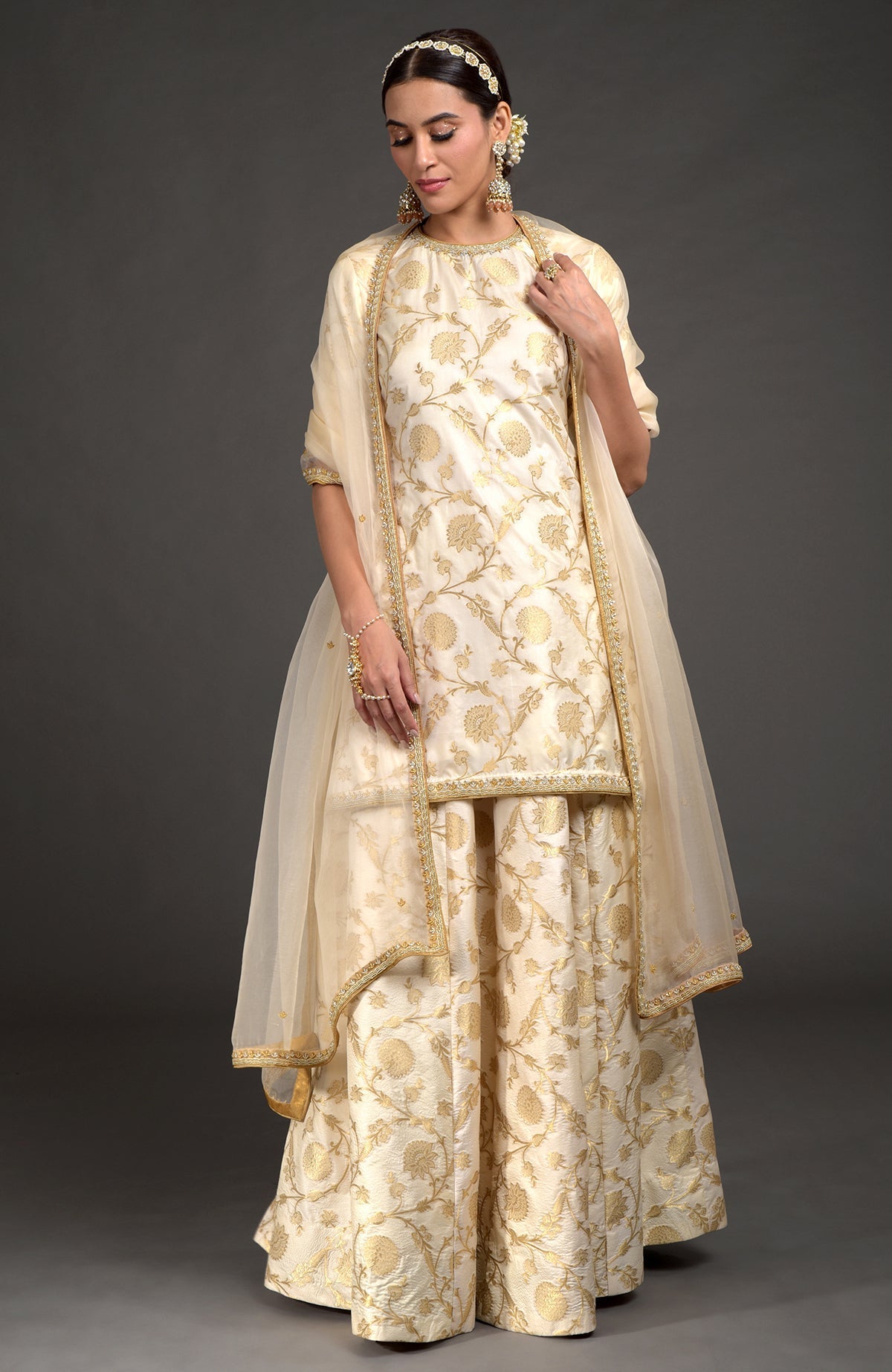 Ivory and gold Benarasi lehenga set with zardozi embroidery on tunic, dupatta, and skirt