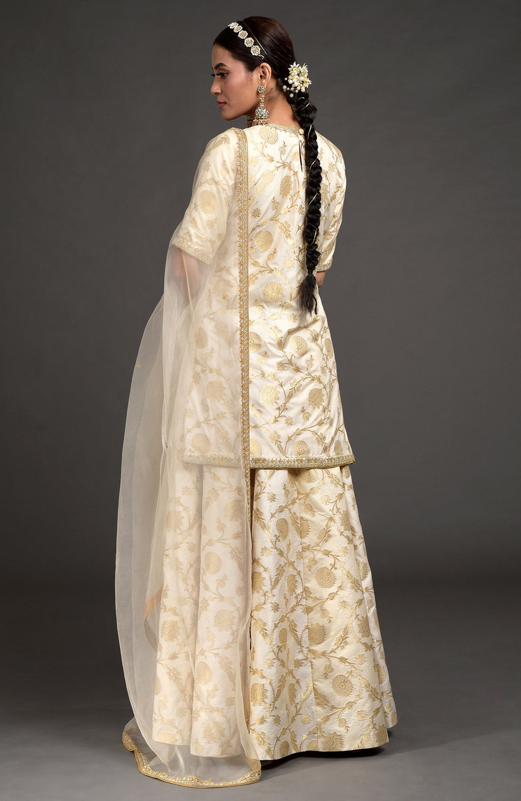 Ivory and gold Benarasi lehenga set with zardozi embroidery on tunic, dupatta, and skirt