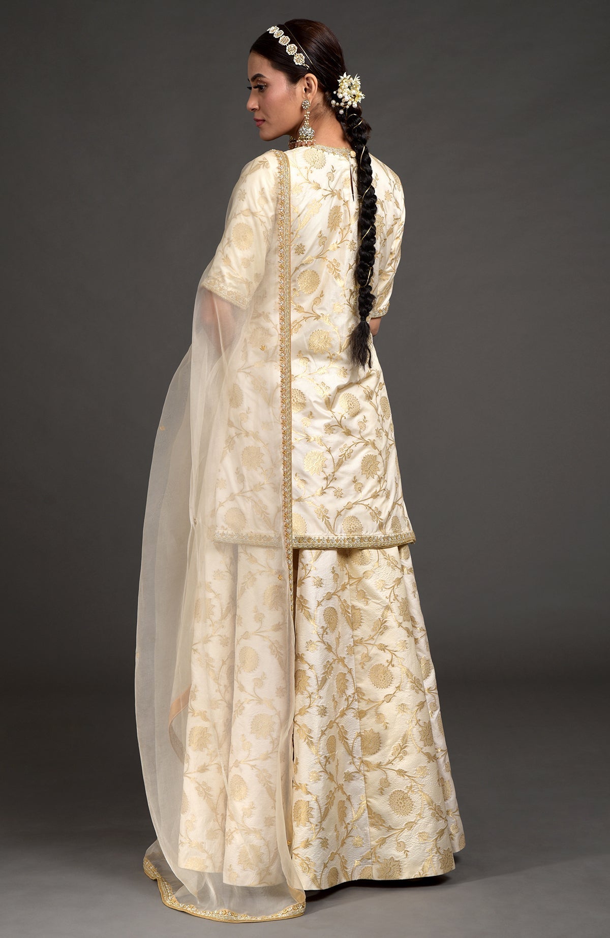 Ivory and gold Benarasi lehenga set with zardozi embroidery on tunic, dupatta, and skirt