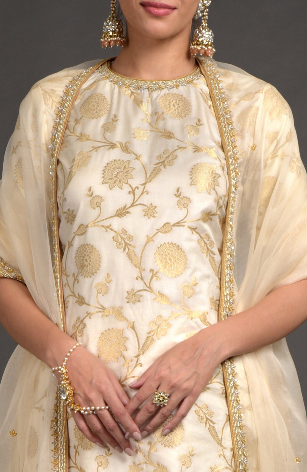 Ivory and gold Benarasi lehenga set with zardozi embroidery on tunic, dupatta, and skirt