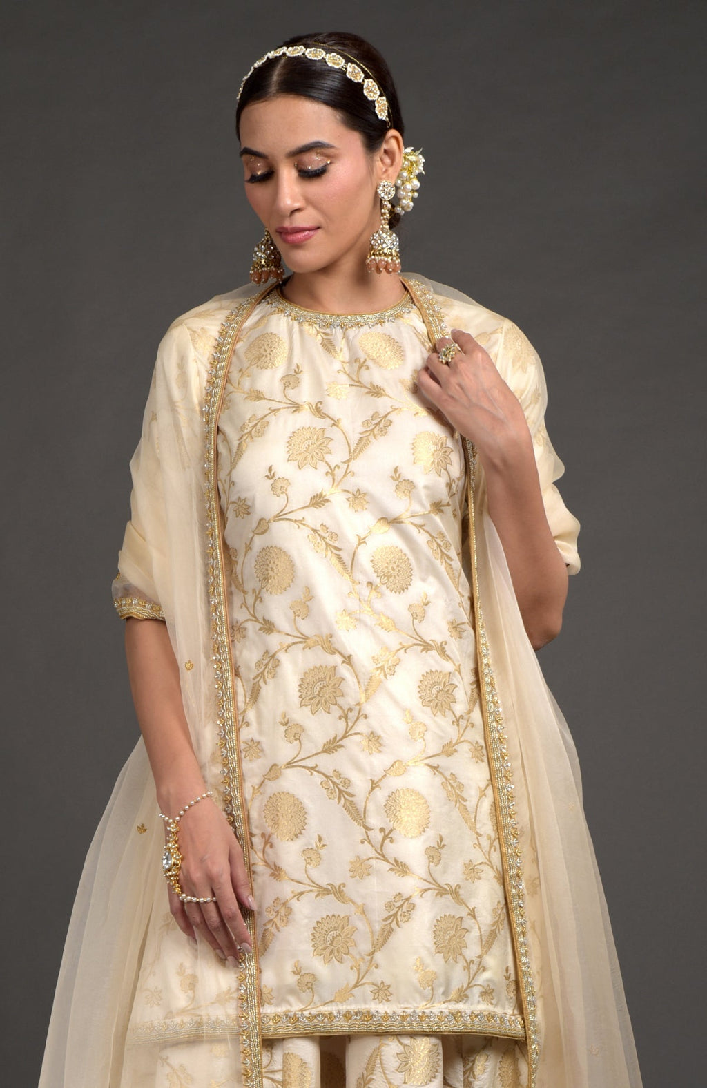 Ivory and gold Benarasi lehenga set with zardozi embroidery, tunic, and beaded dupatta.