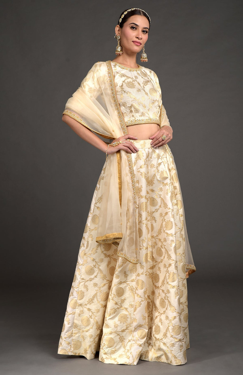 Ivory lehenga set with gold zardozi embroidery, blouse, and dupatta with beaded borders.