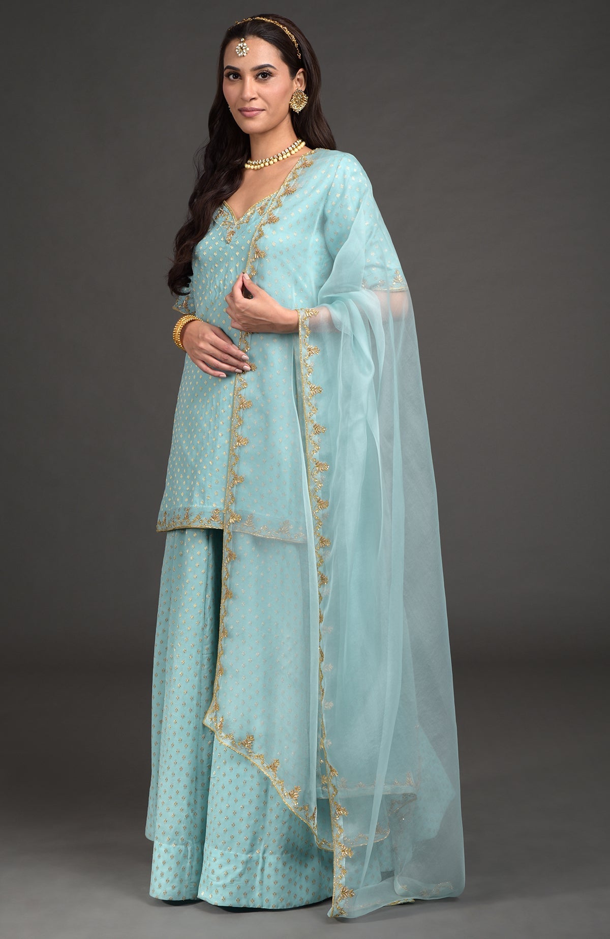 Aqua haze lehenga set with gold Benares weave and floral zardozi hand embroidery details.