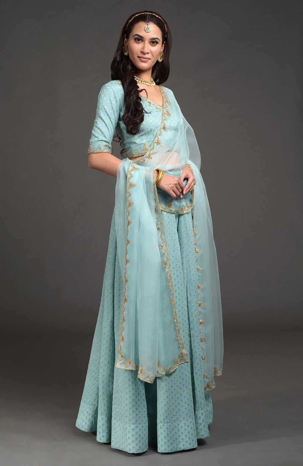 Aqua haze lehenga set with gold Benares weave and floral zardozi hand embroidery details.