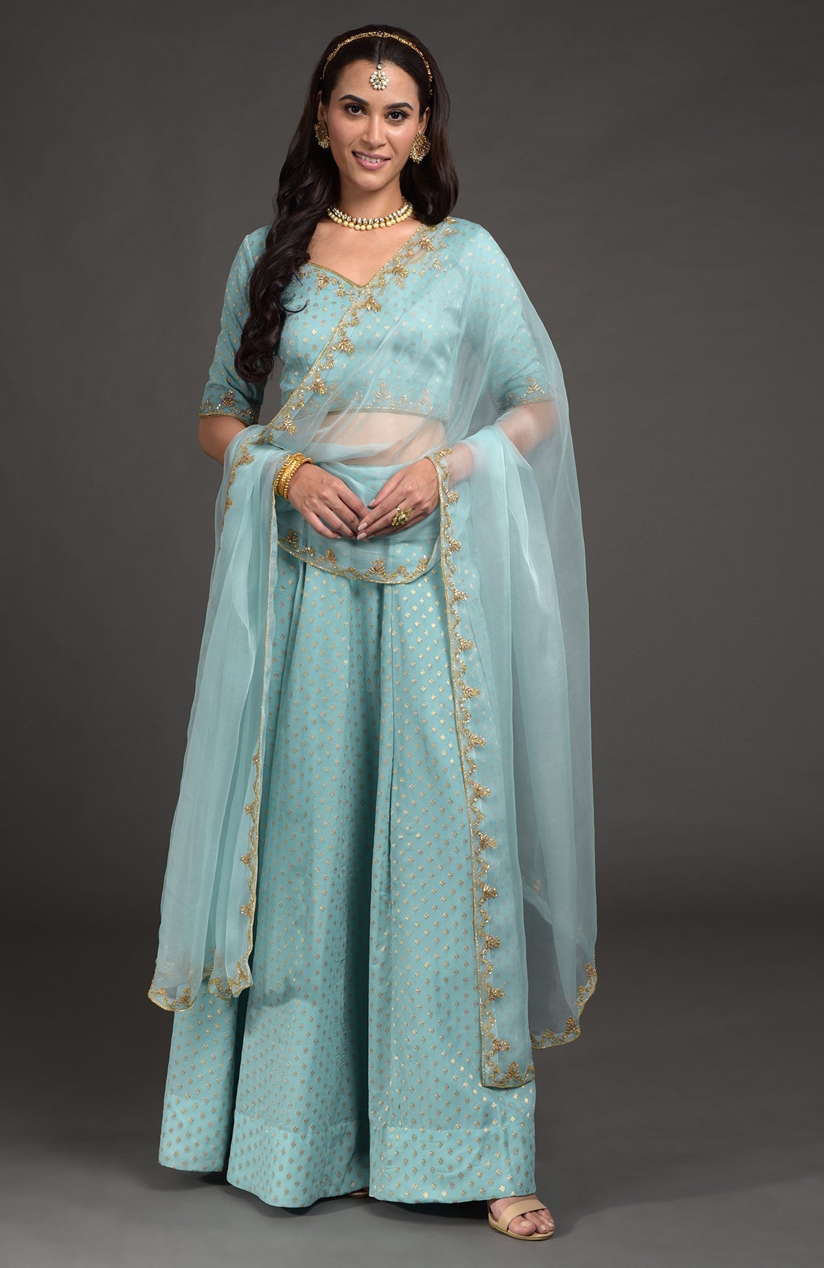 Aqua haze lehenga set with gold Benares weave and floral zardozi hand embroidery details.