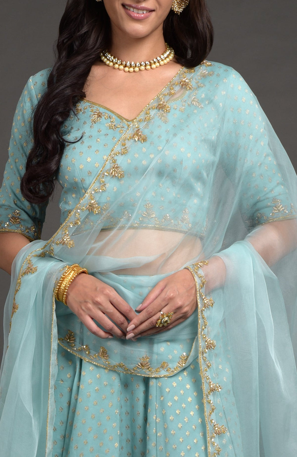 Aqua haze lehenga set with gold Benares weave and floral zardozi hand embroidery