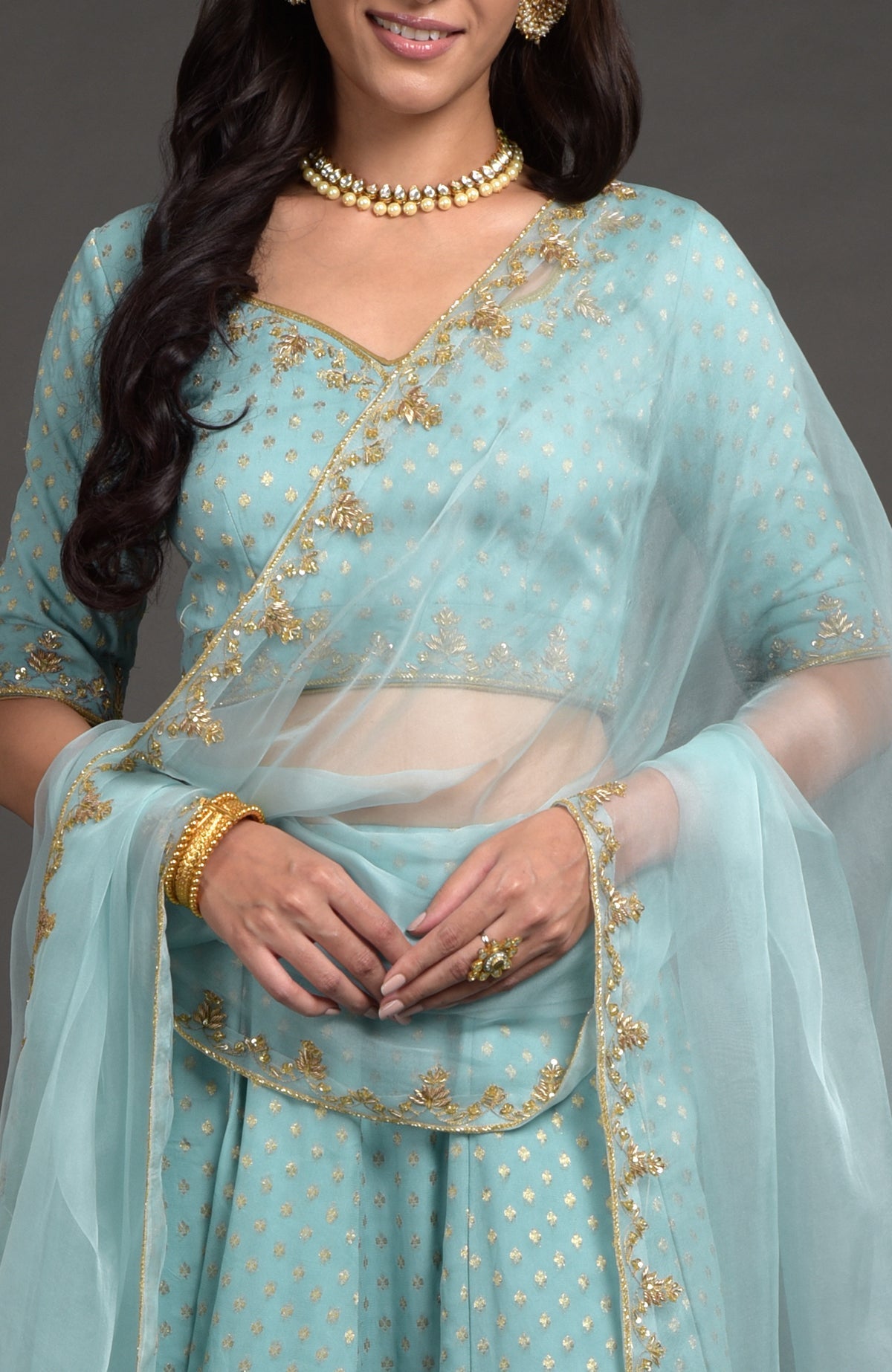 Aqua haze lehenga set with gold Benares weave and floral zardozi hand embroidery